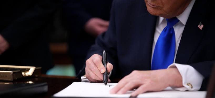 Trump signs order moving thousands of federal employees into Schedule F