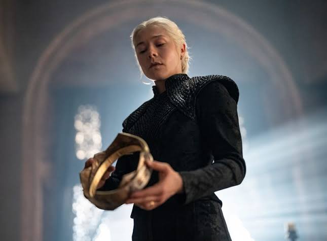 Queen Rhaenyra Targaryen (Emma D'Arcy) contemplates her golden crown in HBO's "House of the Dragon."
