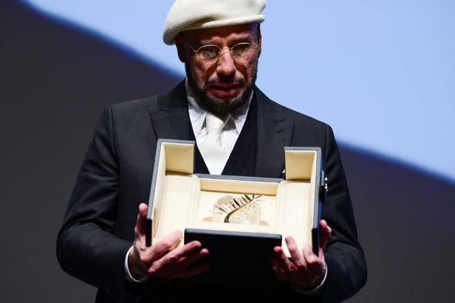 John Travolta cries after surprise award at Cannes Film Festival