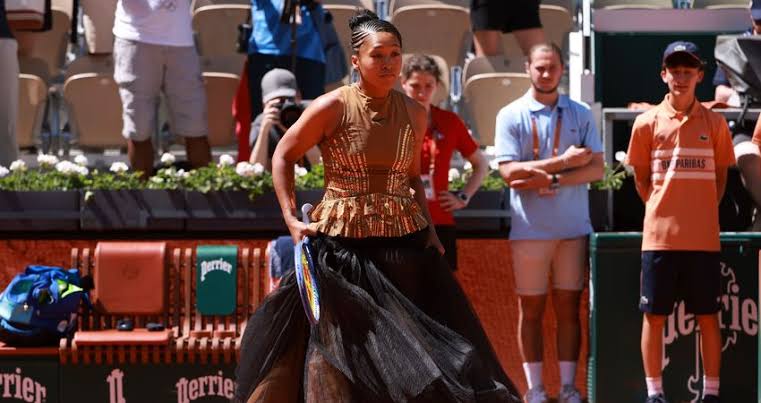 Osaka turns heads with black corset and gold dress at Roland Garros