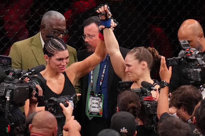 Ronda Rousey defeats Gina Carano in 17 seconds at a high-profile MMA event, retires