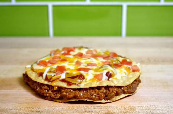 Taco Bell hopes to win back fans with $1 Mexican pizza and lettuce-free deals amid cyclospora source rumors