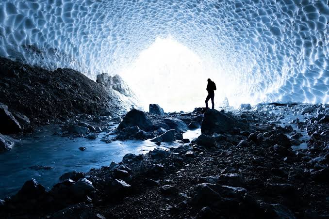 Two and a half kilometres beneath the Antarctic ice, a cubic kilometre of frozen water has been wired with 5,160 light sensors, turning the South Pole itself into a telescope that looks down through the entire planet to catch particles arriving from the other side of