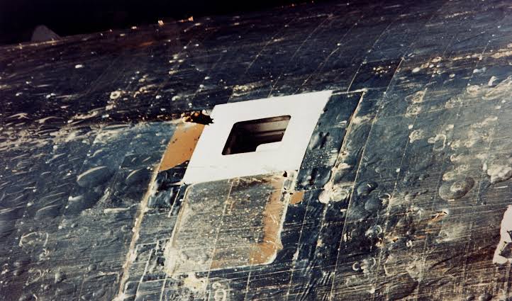 In May 1973, Skylab reached orbit with its heat shield torn away, one solar wing gone and the other jammed, leaving America’s first space station at roughly 54°C — so engineers built a parasol in days and astronauts carried it up to save the laboratory