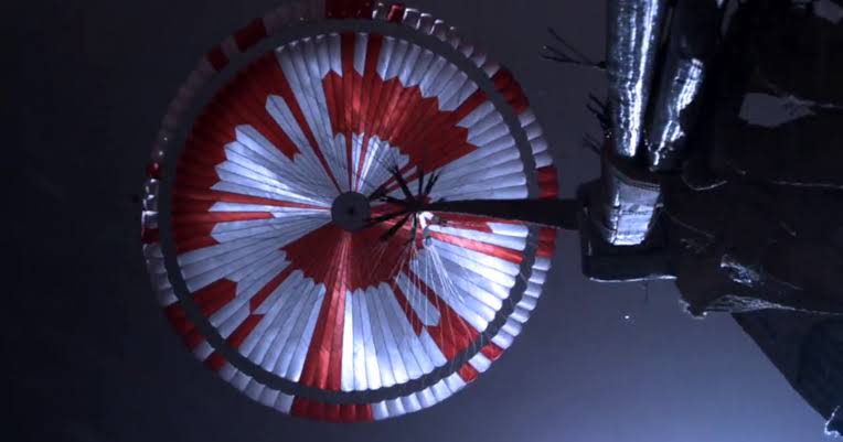 The stripes on Perseverance's parachute were mostly there so engineers could see how the canopy was oriented, but the pattern also hid a message in binary, and the internet decoded it within hours of the landing — a motto, and a set of coordinates pointing