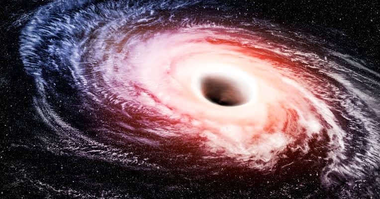 There is a black hole sitting roughly 10 billion light-years away from Earth, called TON 618, with a mass about 66 billion times that of our Sun — more massive than every star in the Milky Way galaxy combined — and its outer edge stretches across a region of s