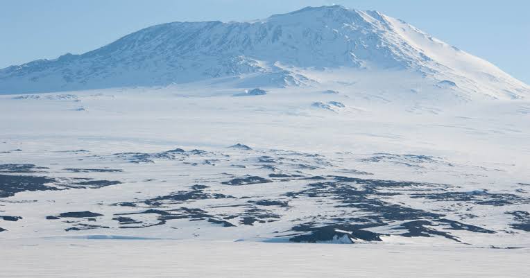 More than 45,000 meteorites have been collected from Antarctica, not because more fall there, but because flowing ice carries dark rocks into blue-ice stranding zones while the wind strips away snow, concentrating pieces of the Moon, Mars and asteroids on o