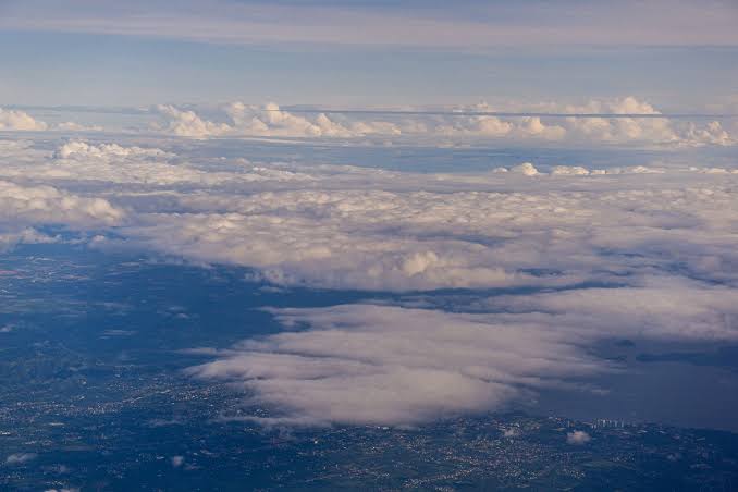 Astronauts who have seen the whole Earth at once describe the overview effect — every war and border and argument hanging in silence — and afterwards traffic and small talk can feel strangely far away, like the world seen through glass