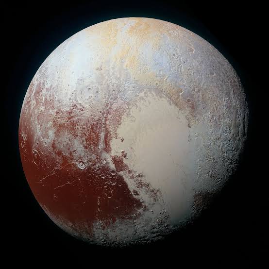 Titan and Pluto exhibit the same mysterious spectral feature—and researchers can't figure out its origin