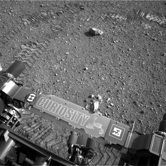 Every turn of Curiosity’s six aluminium wheels stamps the letters JPL into Mars in Morse code — a signature hidden in dots and dashes that is not merely decorative, because the rover photographs those tracks to measure how far its wheels slipped on sand an