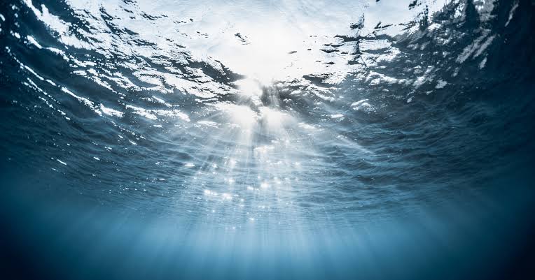 Earth's largest waterfall is hidden underwater in the Denmark Strait between Iceland and Greenland, where dense cold water plunges about 3,500 meters down the seafloor, far exceeding any waterfall on land in drop height and volume