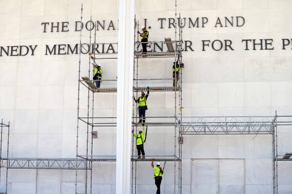 Workers begin to remove Trump’s name from the Kennedy Center, in photos